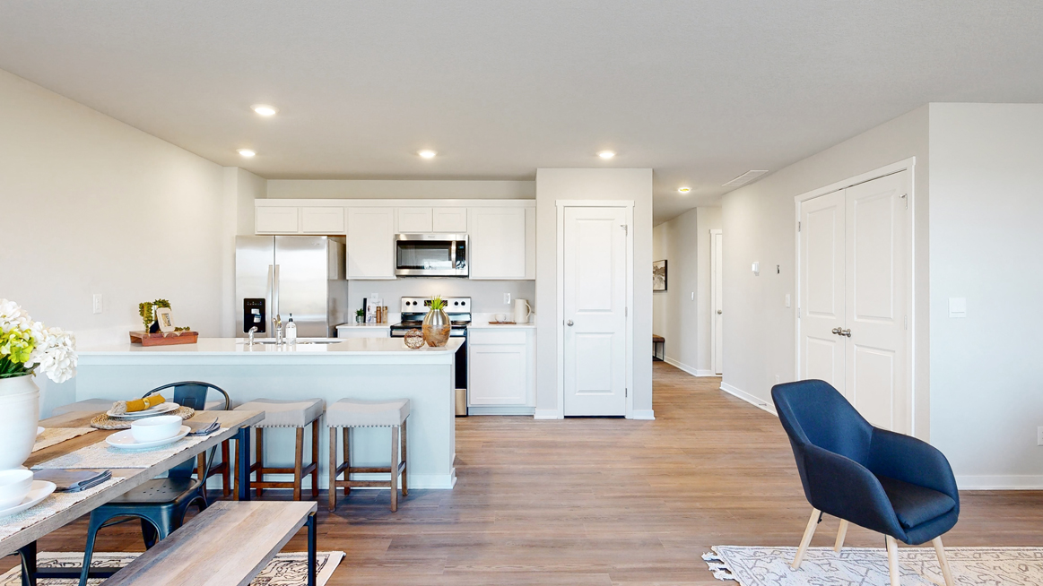 Open concept dining area and kitchen looking down the foyer in the Freeport