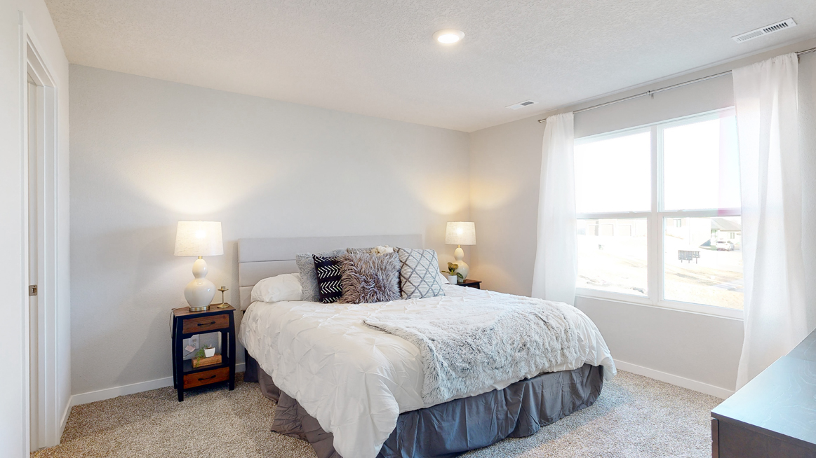 Spacious primary bedroom in the Freeport with a king bed and two nightstands