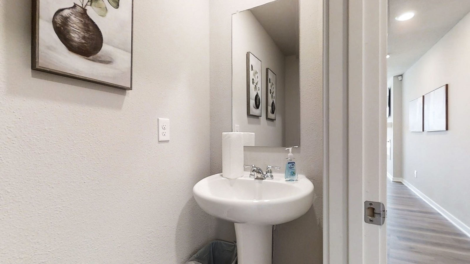 Half bathroom with sink and toilet located in the foyer of the Emerson