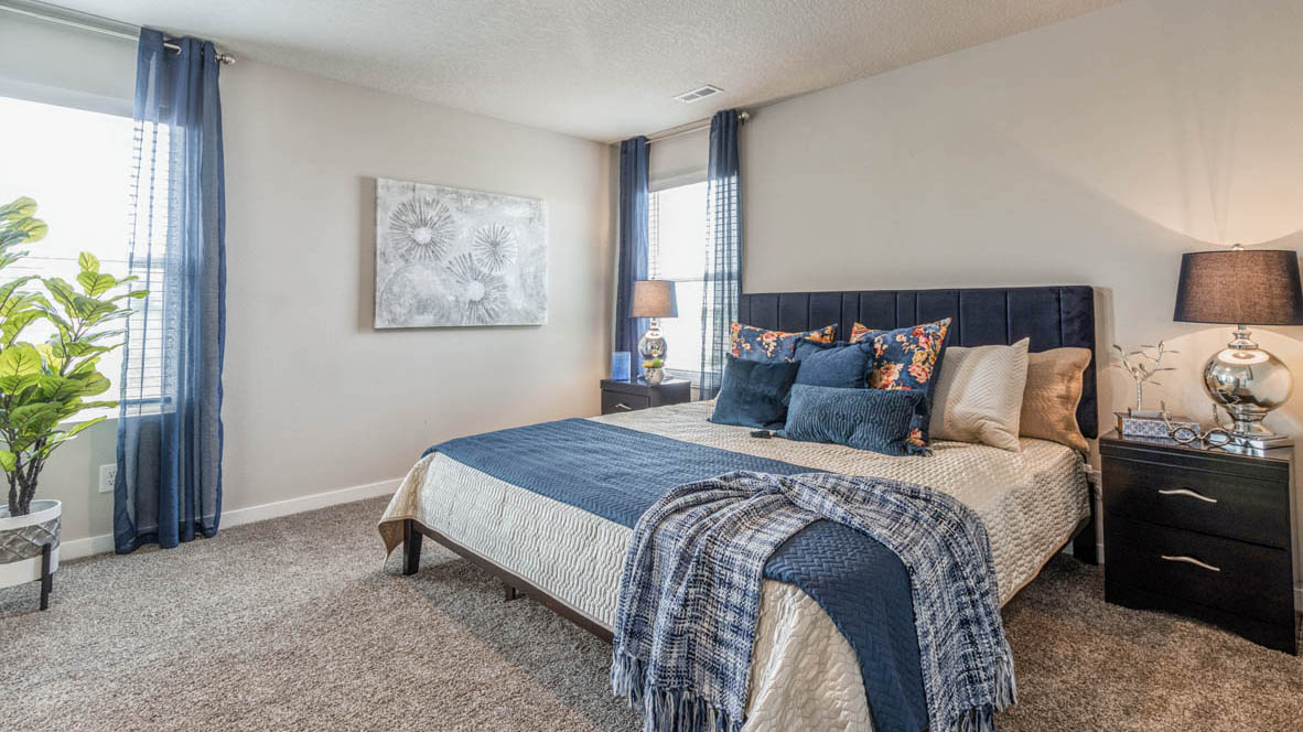 Spacious Emerson primary bedroom with king bed and two windows