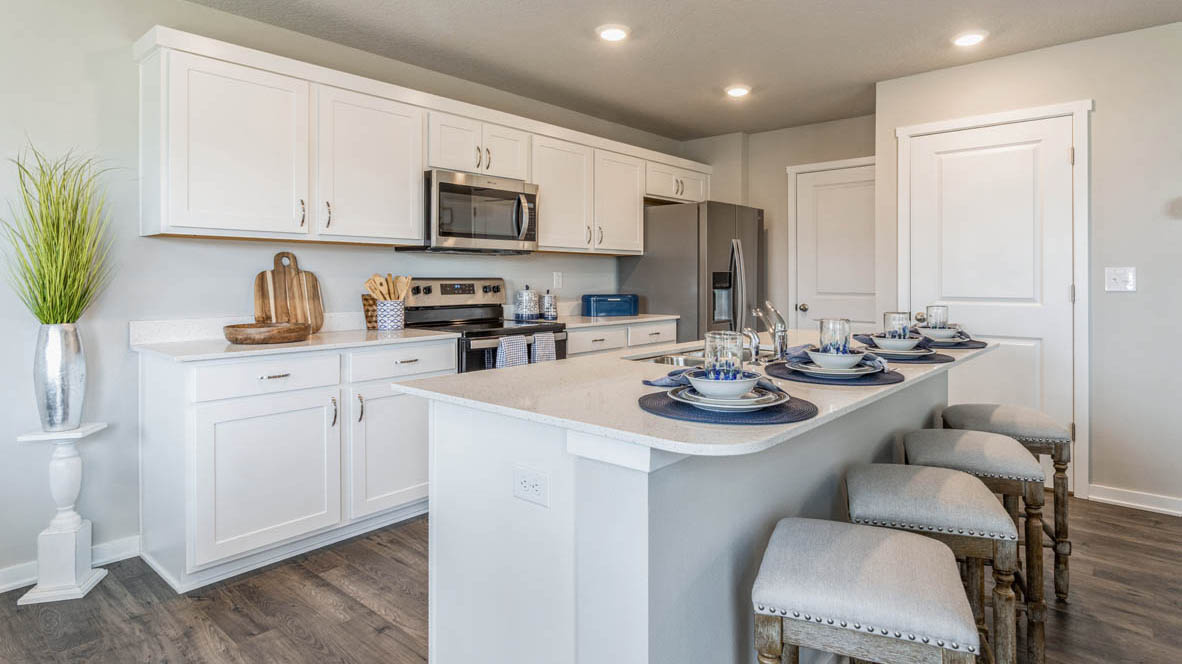 Modern kitchen in the Emerson with island and barstools