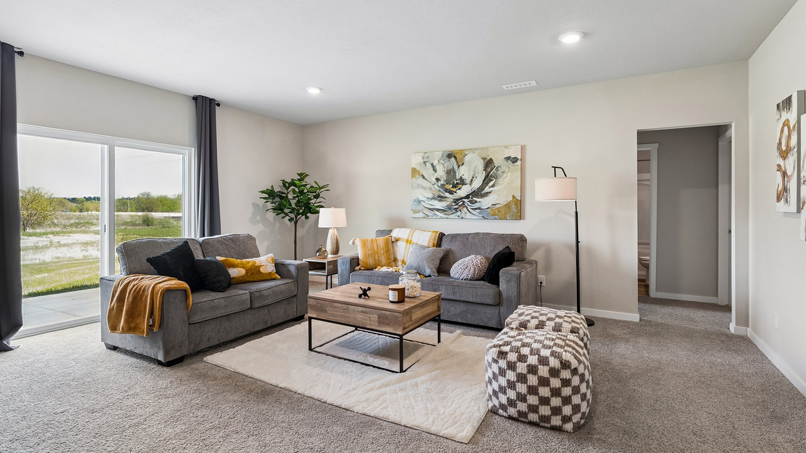 Hamilton finished basement living room with two couches and two ottomans