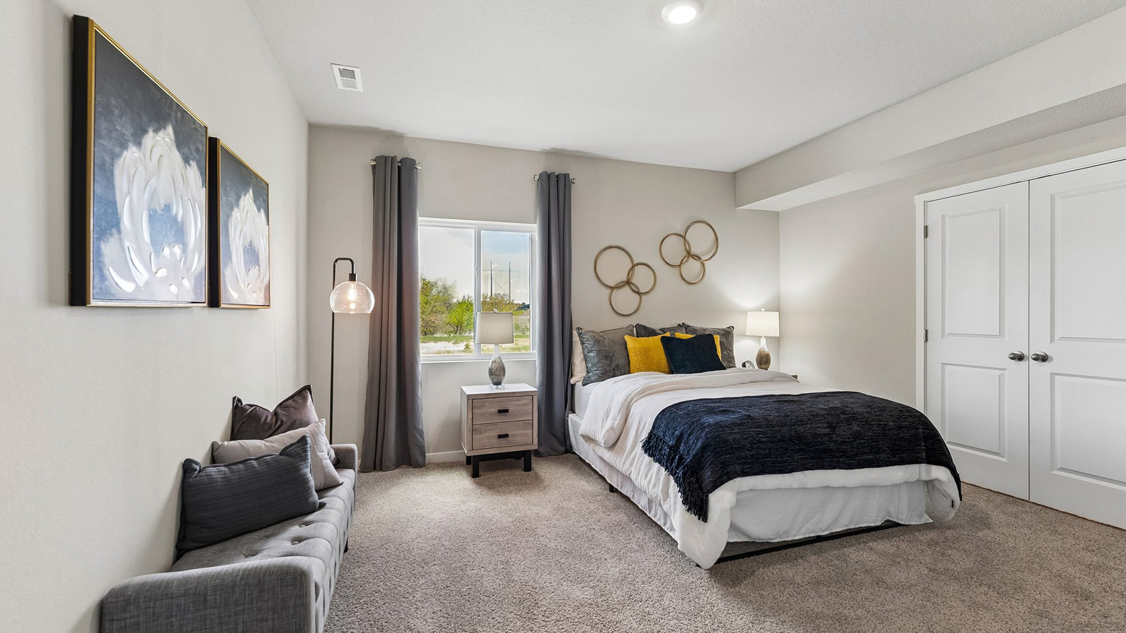Fourth bedroom in the Hamilton finished basement with large window and french door closet