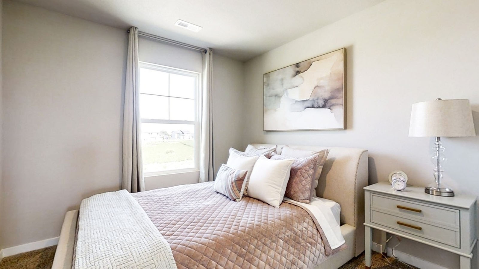 Third bedroom in the Edmon with a queen bed and nightstand