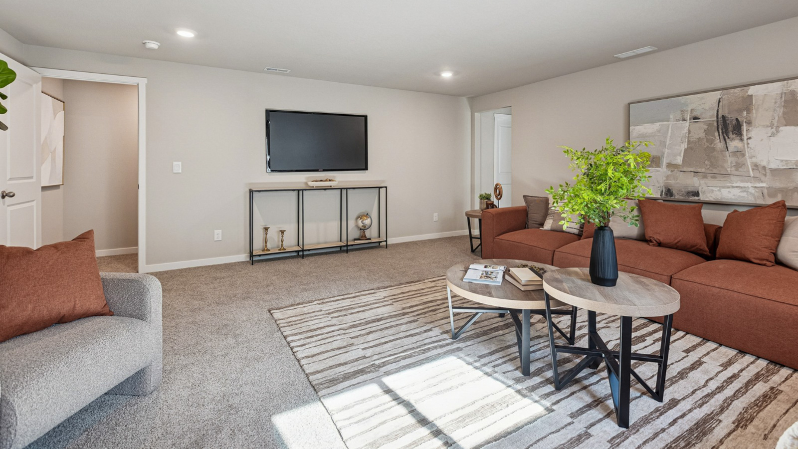 Hamilton finished basement living room with TV showing entrace to stairs and bedroom