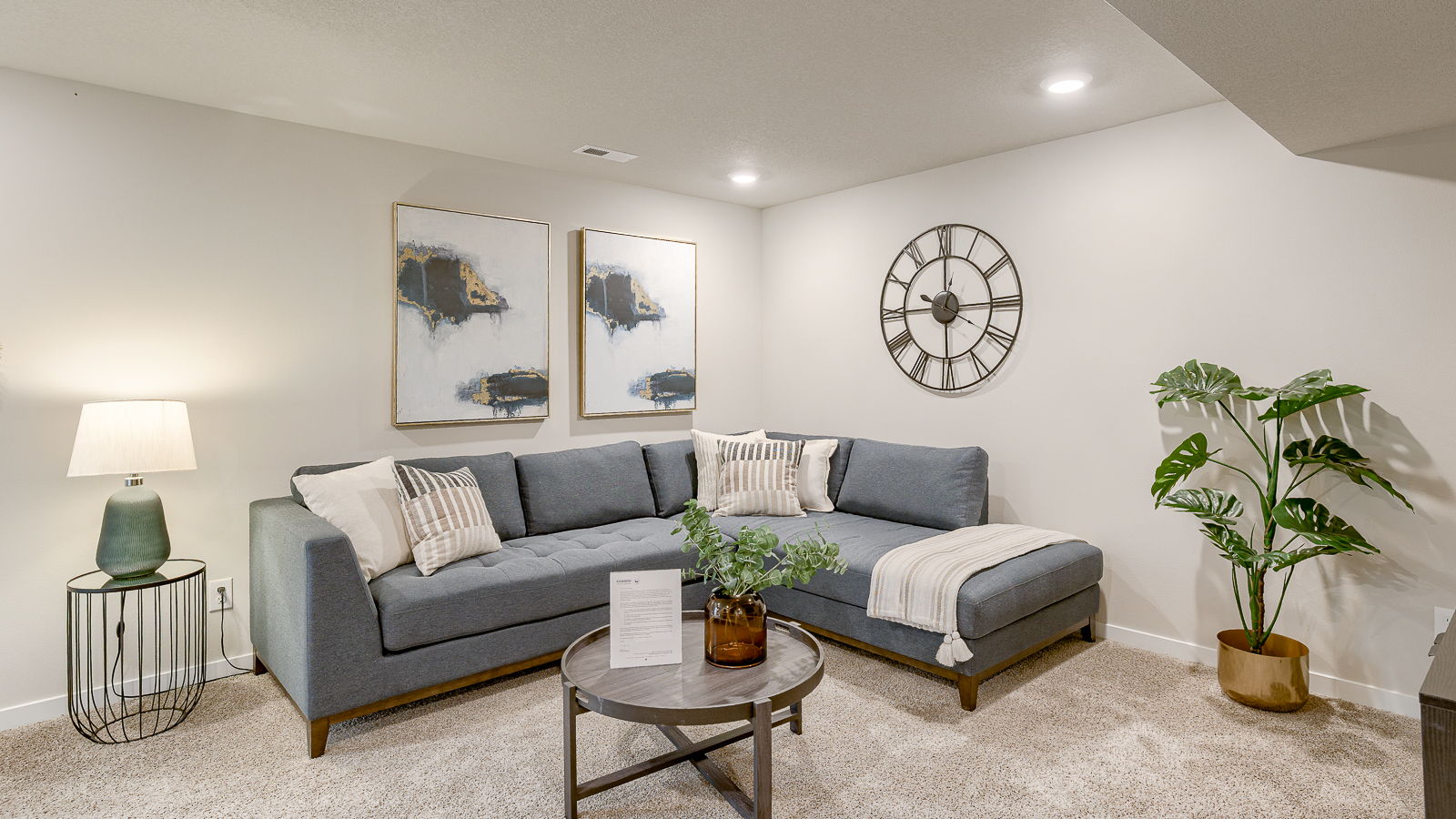 Bellhaven finished basement living room with a couch and green accented decor