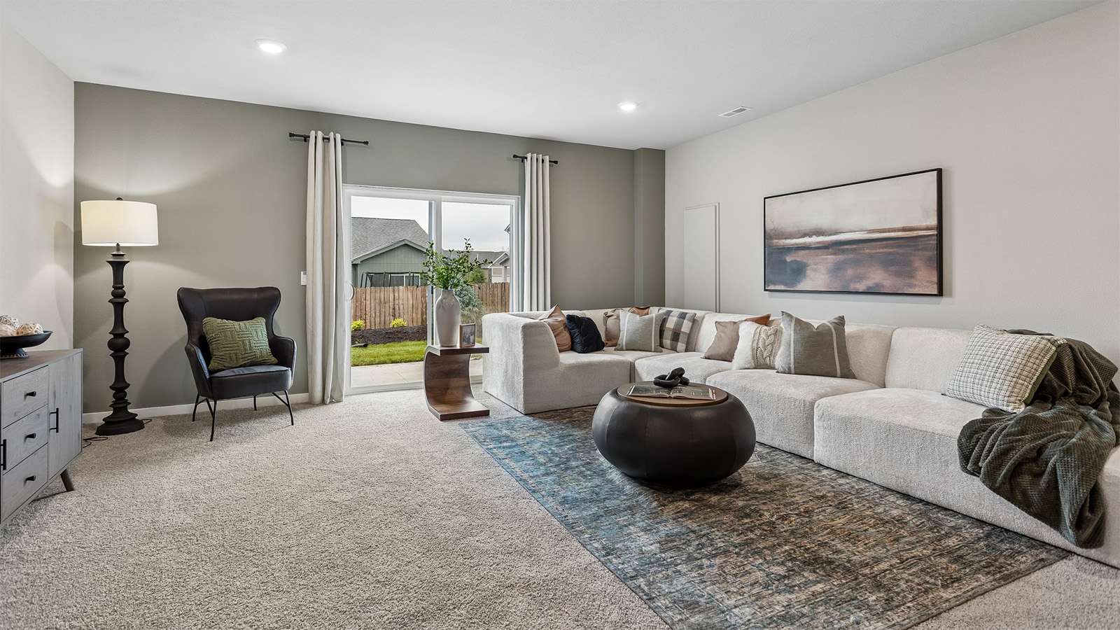 Neuville finished basement living room with large sectional couch