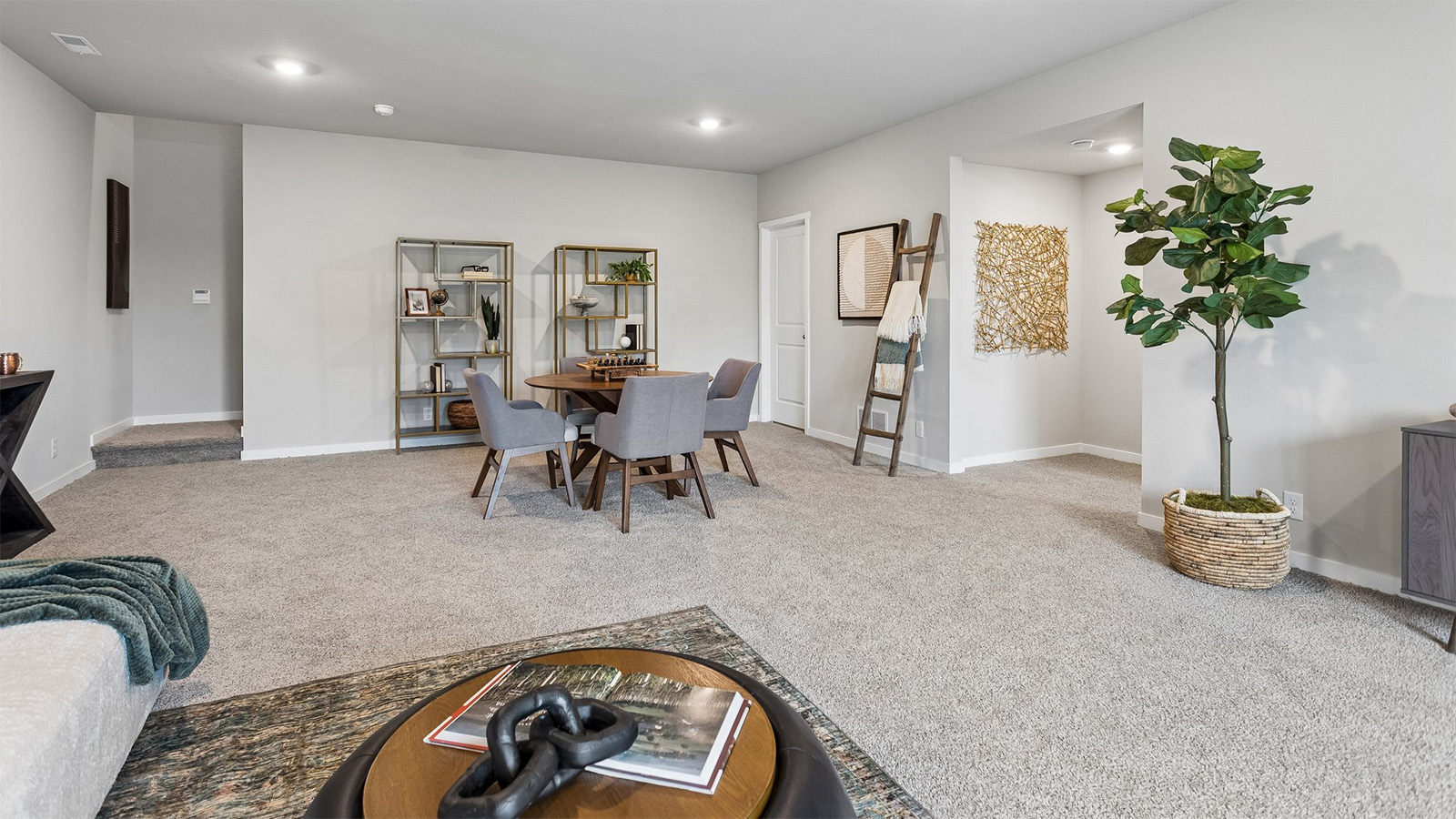 Neuville finished basement living room showing second seating area and stairs landing
