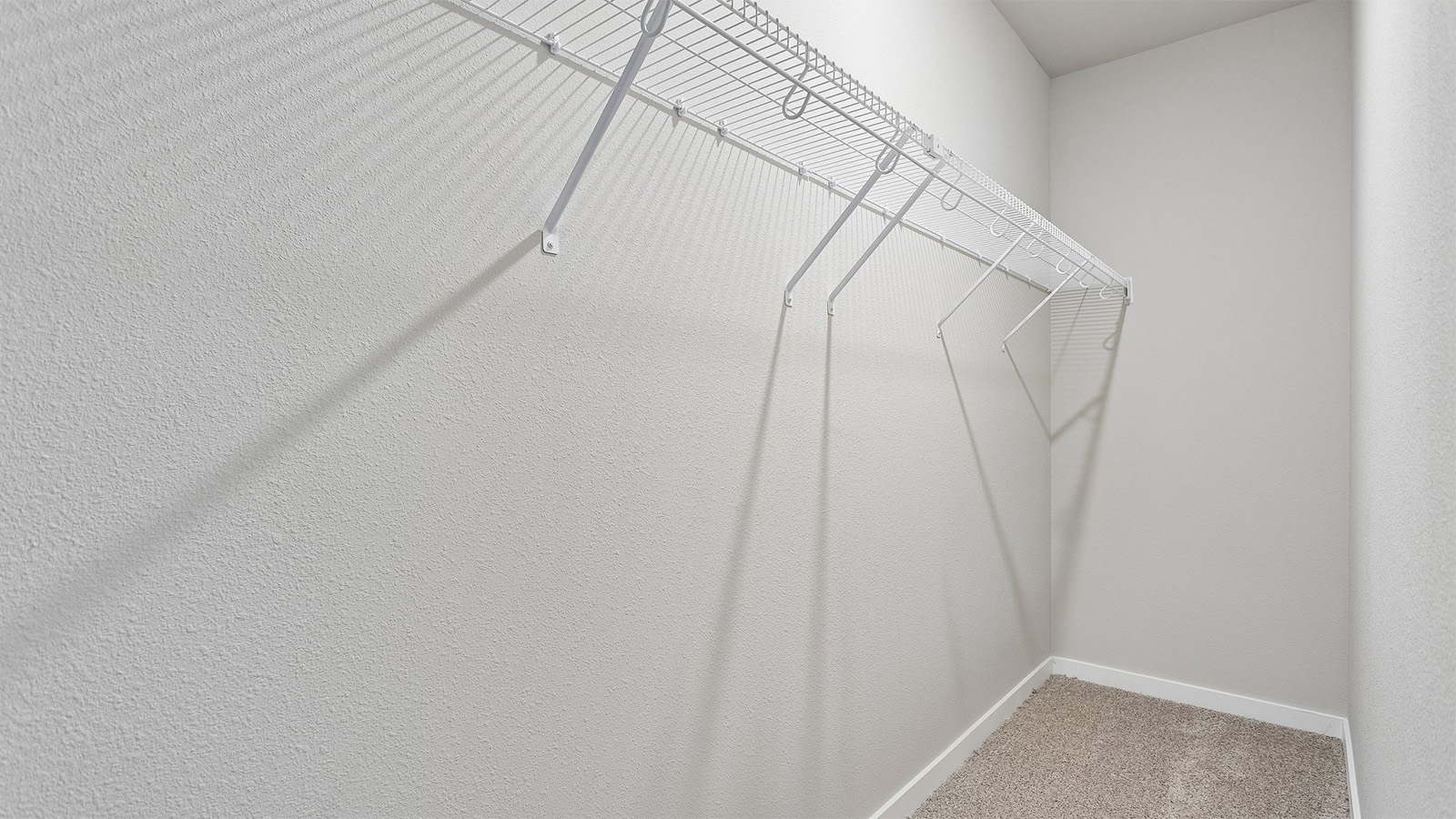 Deep walk-in closet in the fourth bedroom of the Neuville finished basement