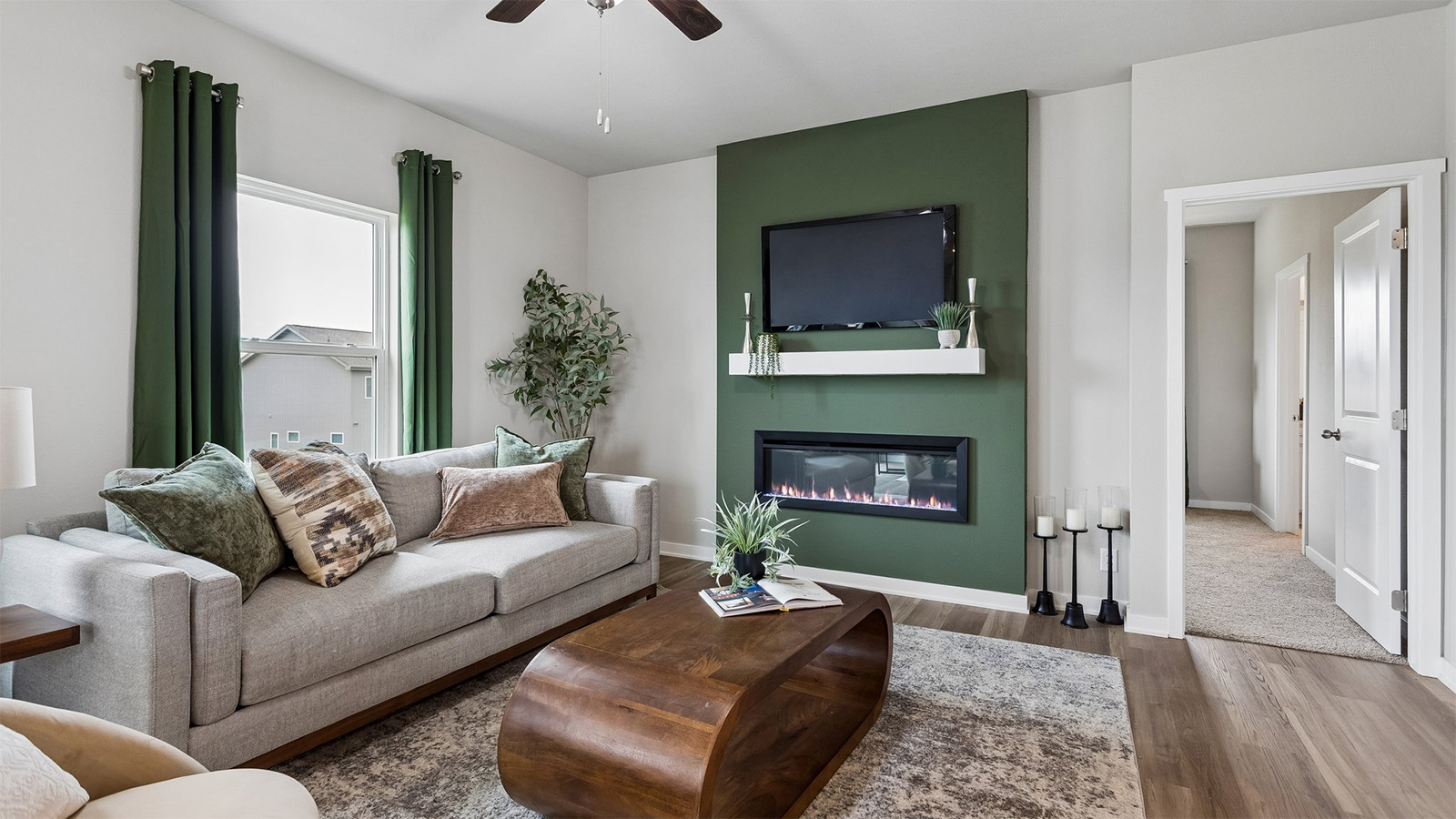 Neuville living room with electric fireplace and green accent wall