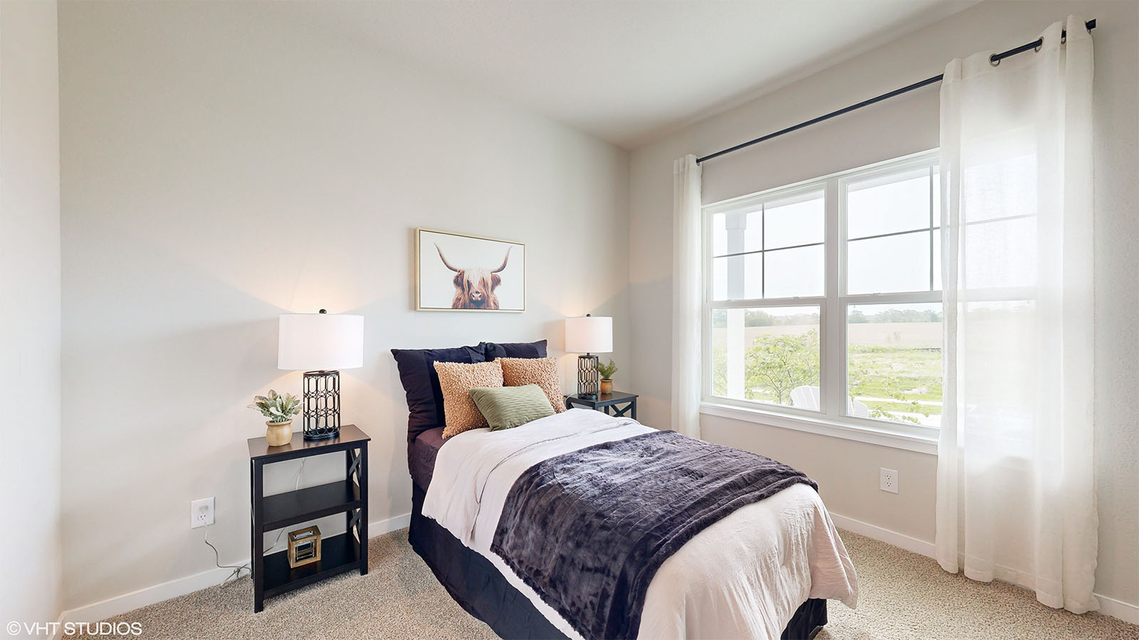 Second bedroom in the Fairfield with a twin bed two nightstands and a bright double window
