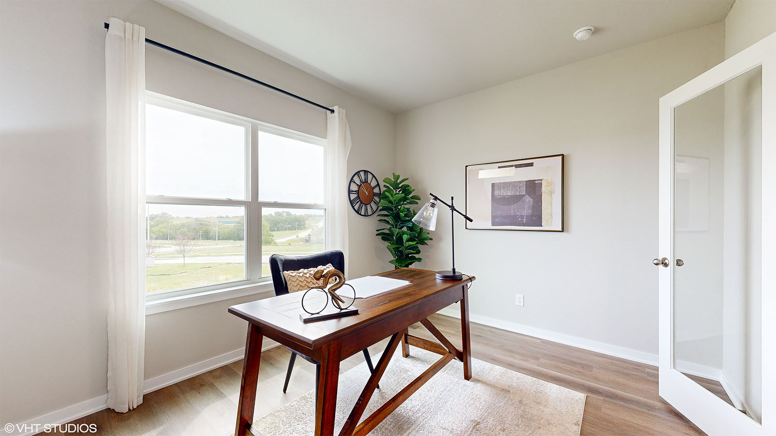 Home office in the Fairfield with a desk and chair featuring glass french door entry