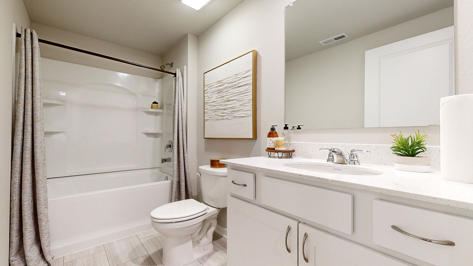 Fourth bathroom in the finished basement of the Fairfield with a bathtub toilet and sink