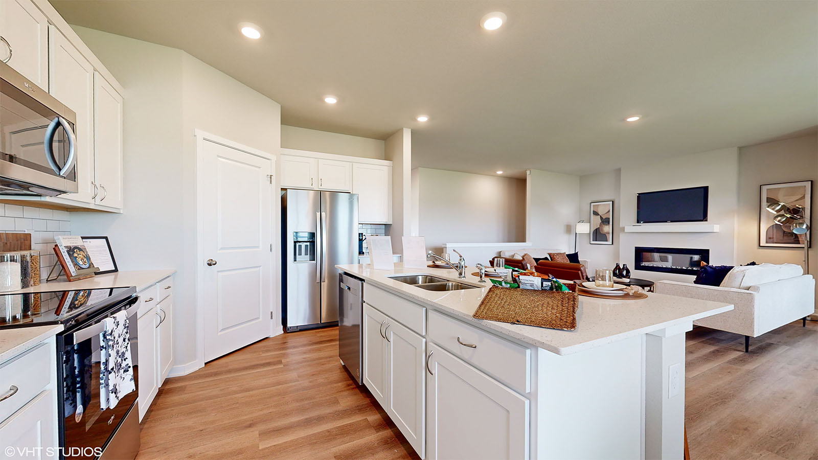 Fairfield kitchen overview showing walk-in pantry door and overlooking living room