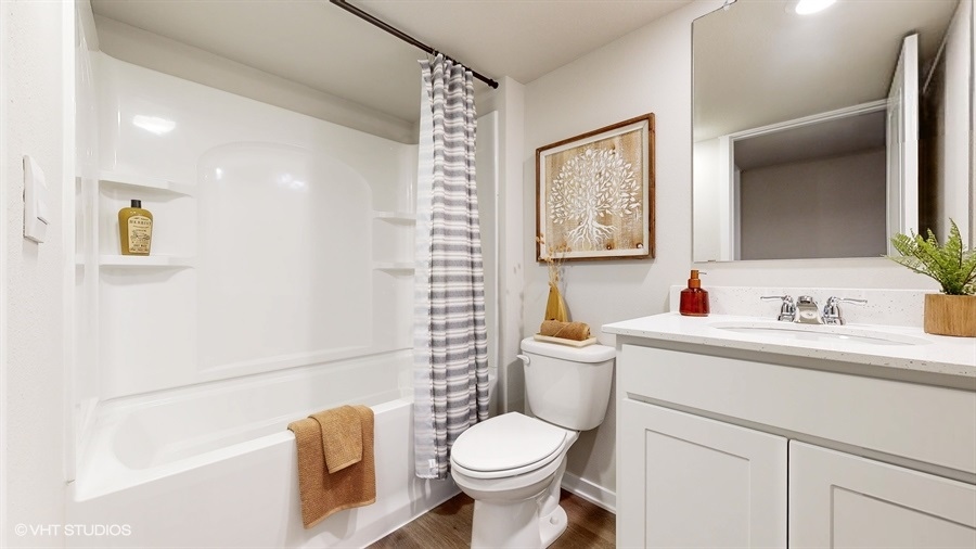 Third bathroom in finished Abbott basement with tub sink and toilet