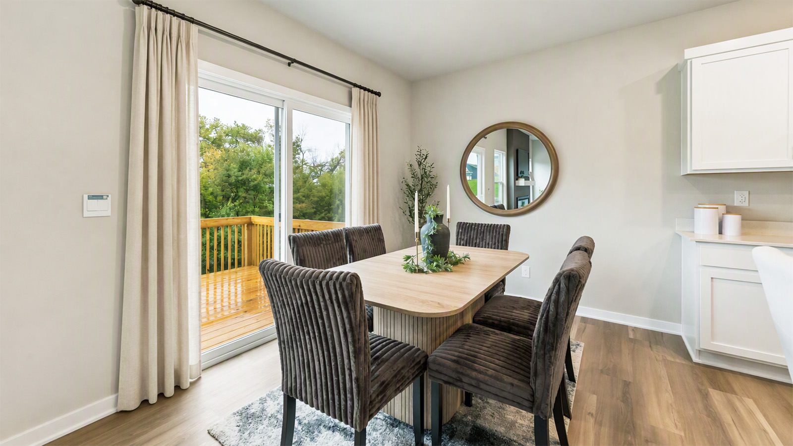 Hamilton dining area with table that seats six and sliding glass doors leading to deck