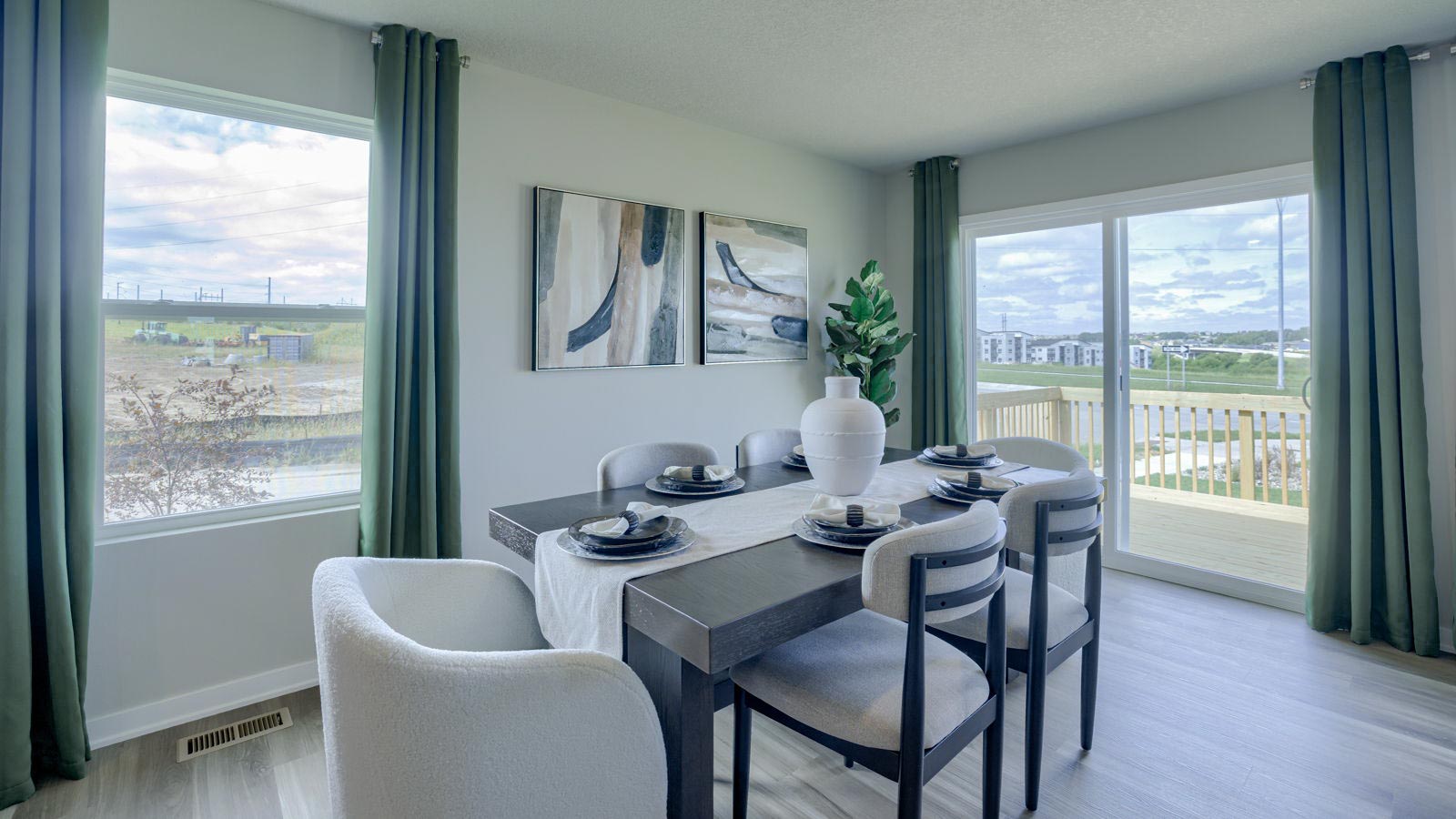 Neuville dining area with table and chairs featuring a large window and sliding glass doors