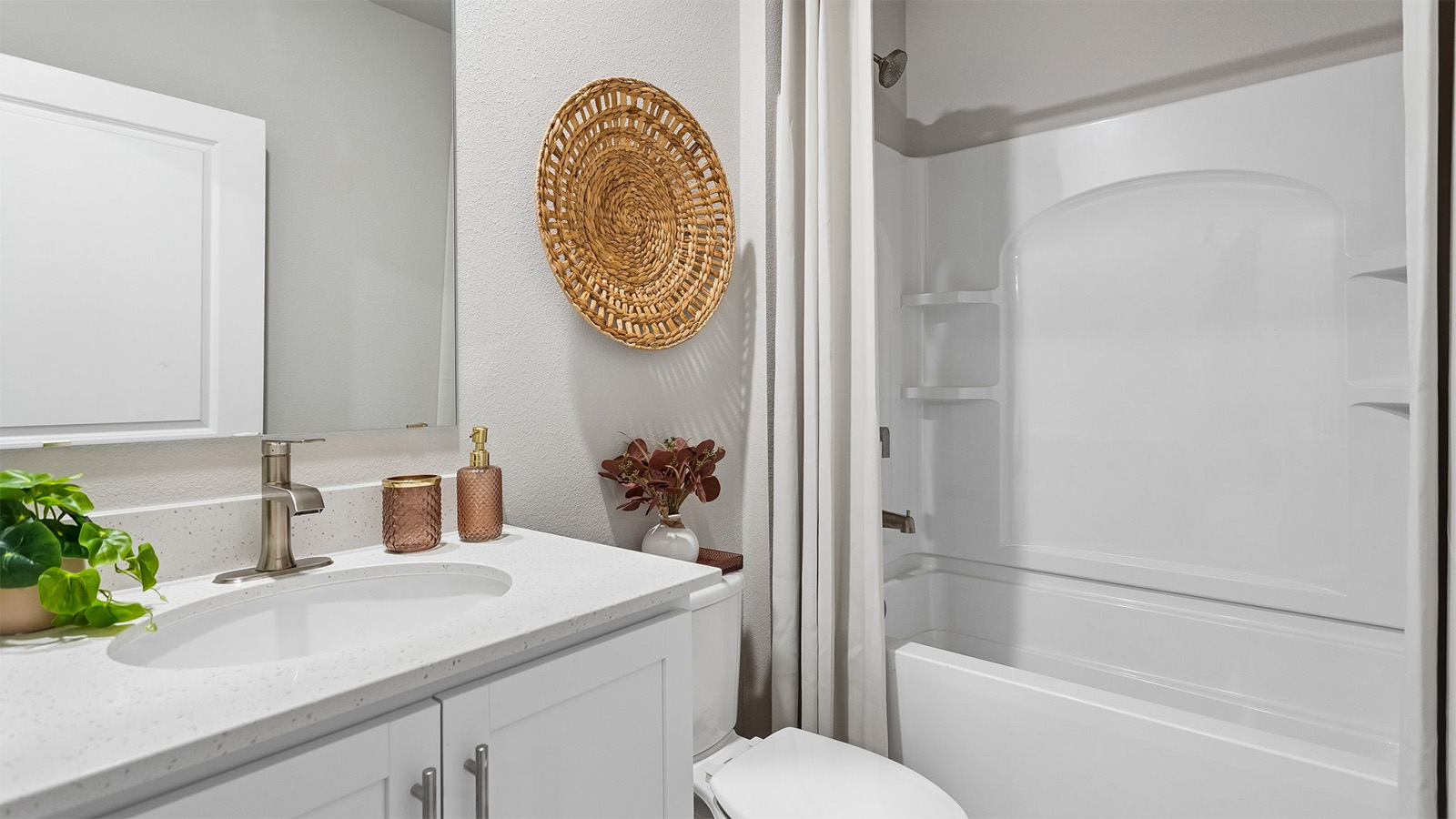 Third bathroom in the Neuville finished basement with a bathtub