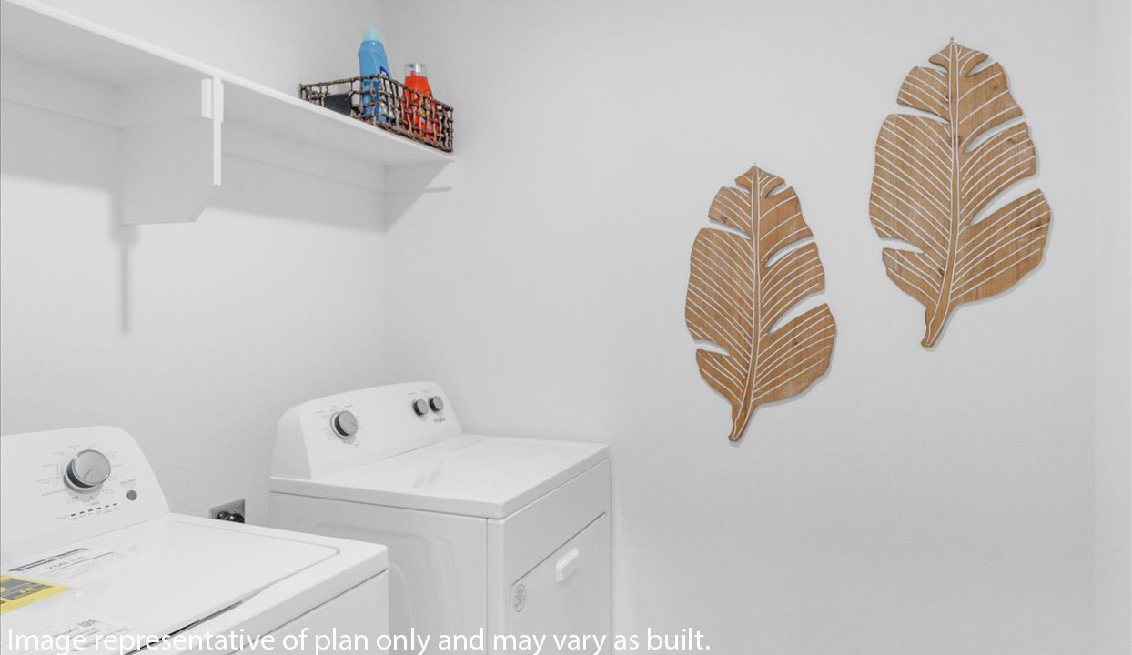 Laundry room with white cabins and washer/dryer unit.