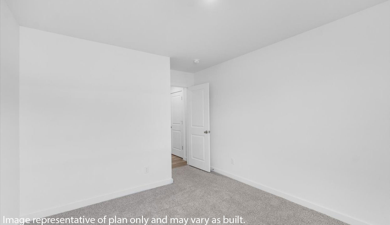 Bedroom with white walls and gray carpet