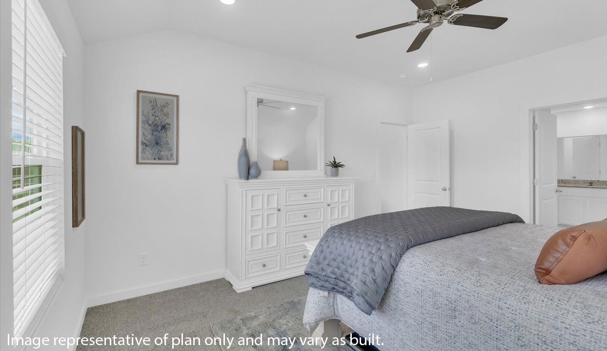 Primary Bedroom with white walls, gray carpet and ceiling van. Doorway into the living area.