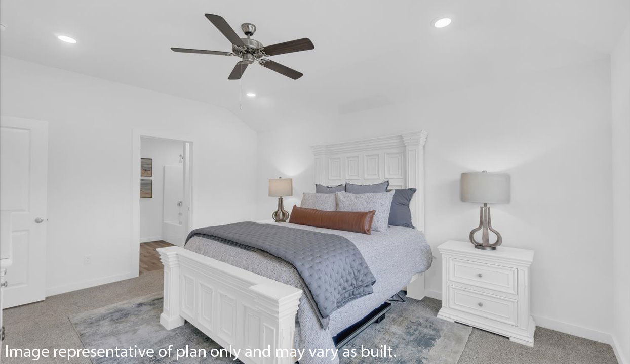 Primary Bedroom with white walls, gray carpet and ceiling van. Doorway into the master bathroom.