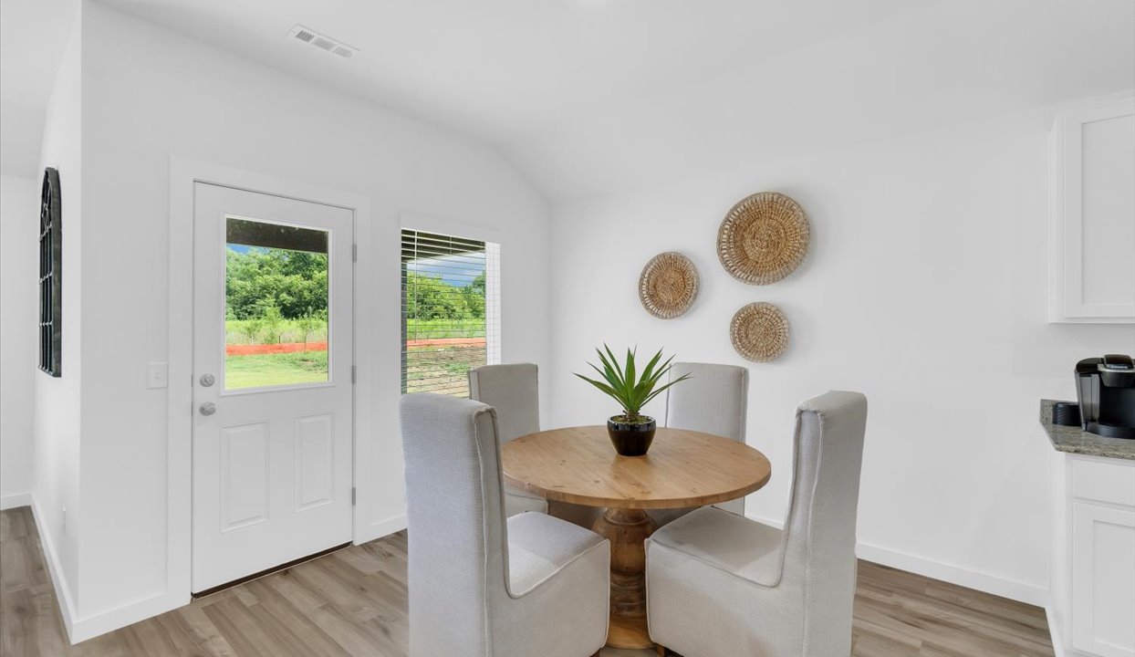 Spacious breakfast nook with door leading out to the patio.