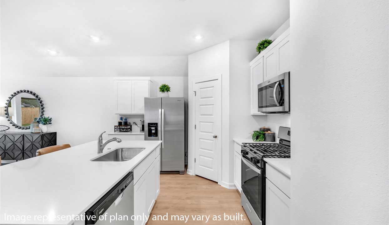 Kitchen peninsula with white cabinets and modern stainless steel appliances.