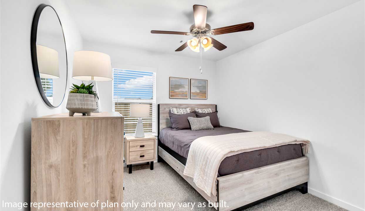 Spacious bedroom with white walls, carpet, one window and ceiling fan.