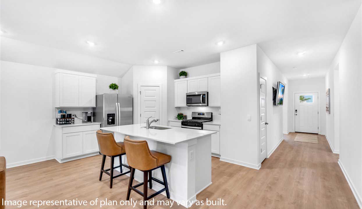 Kitchen peninsula with white cabinets and modern stainless steel appliances.