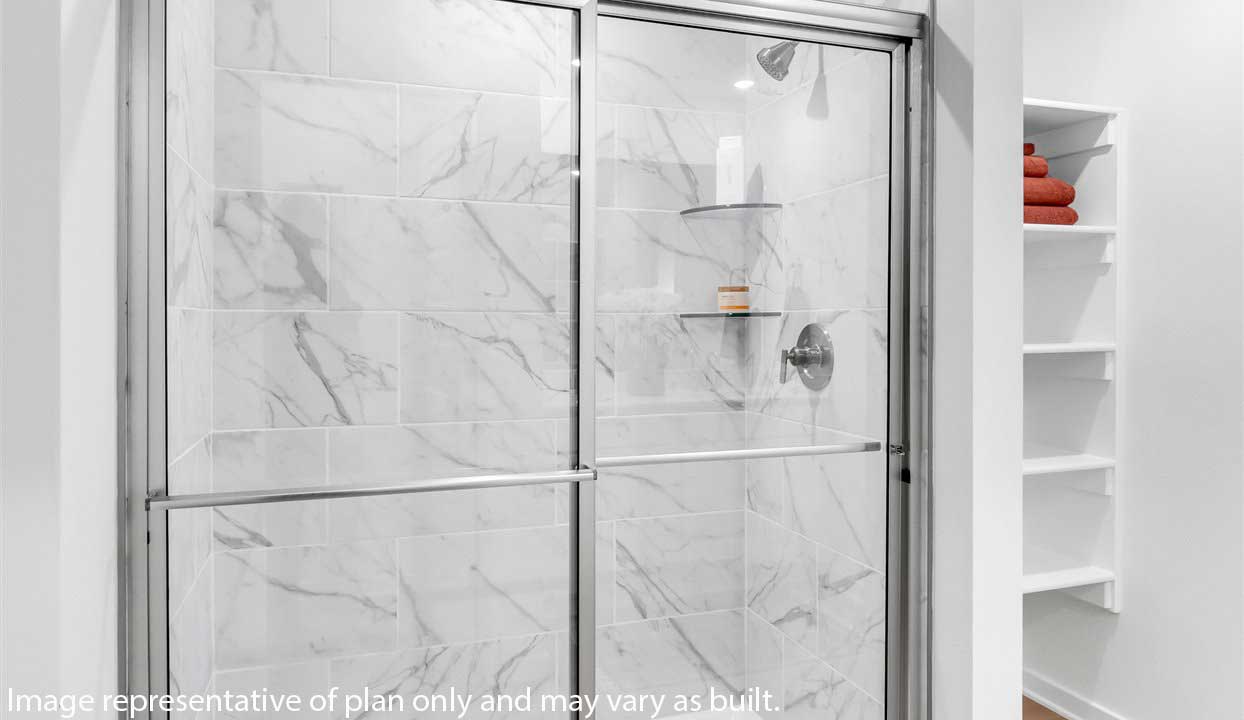 Modern bathroom featuring a walk in showerwith marble tile next to built in Shelves.
