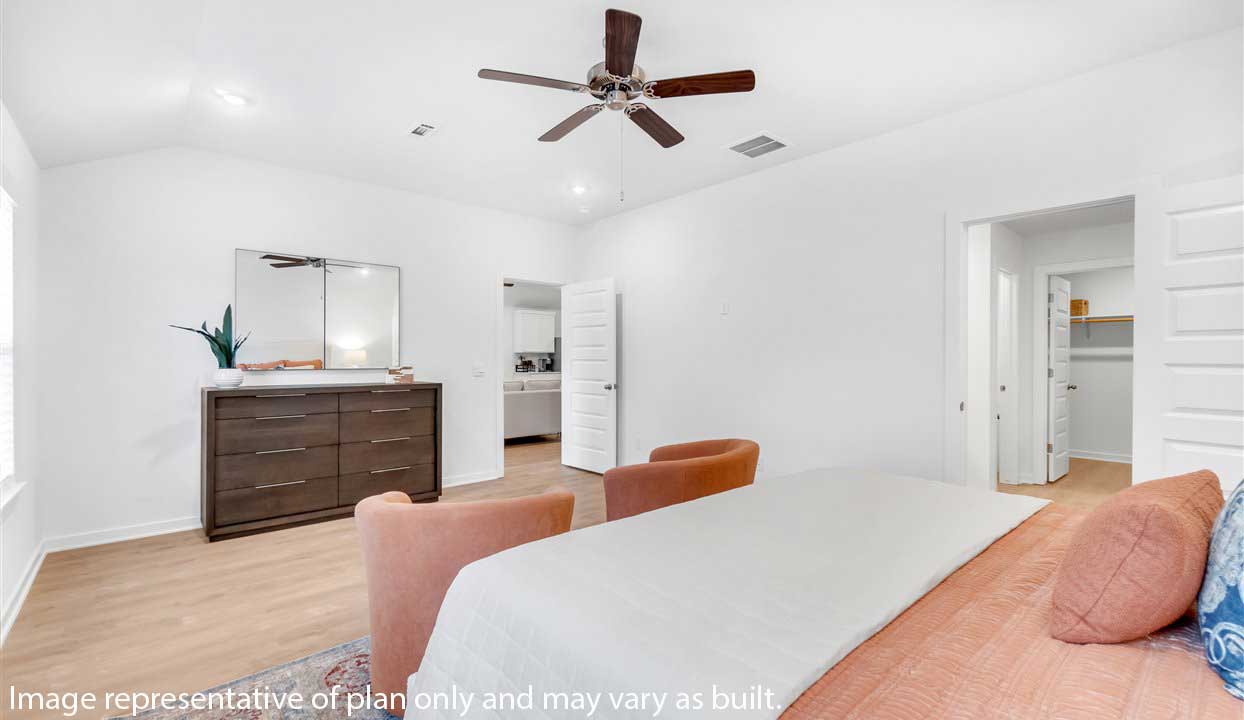 Spacious master bedroom with a large bed and matching nightstands.