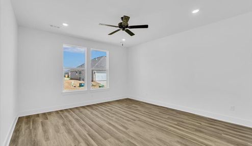 Master Bedroom with white walls, ceiling van,with two windows.