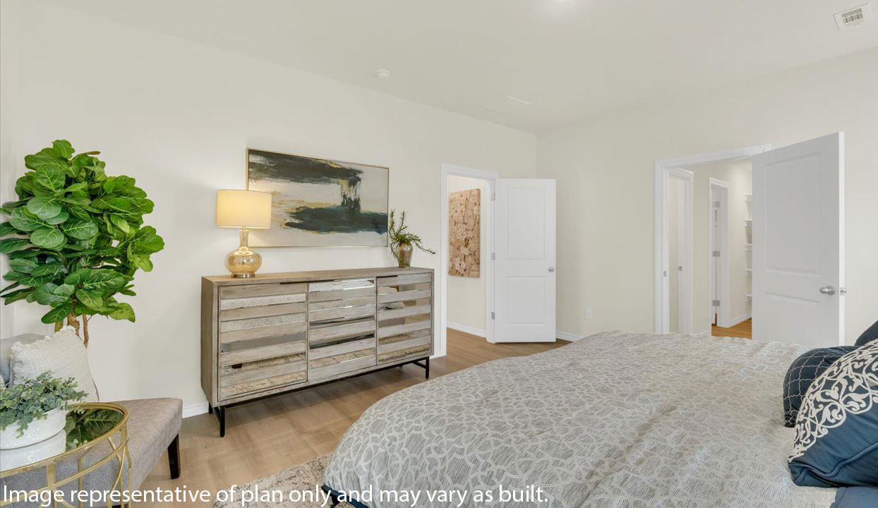 Primary Bedroom with white walls. Doorways leading into the master bathroom and living area.
