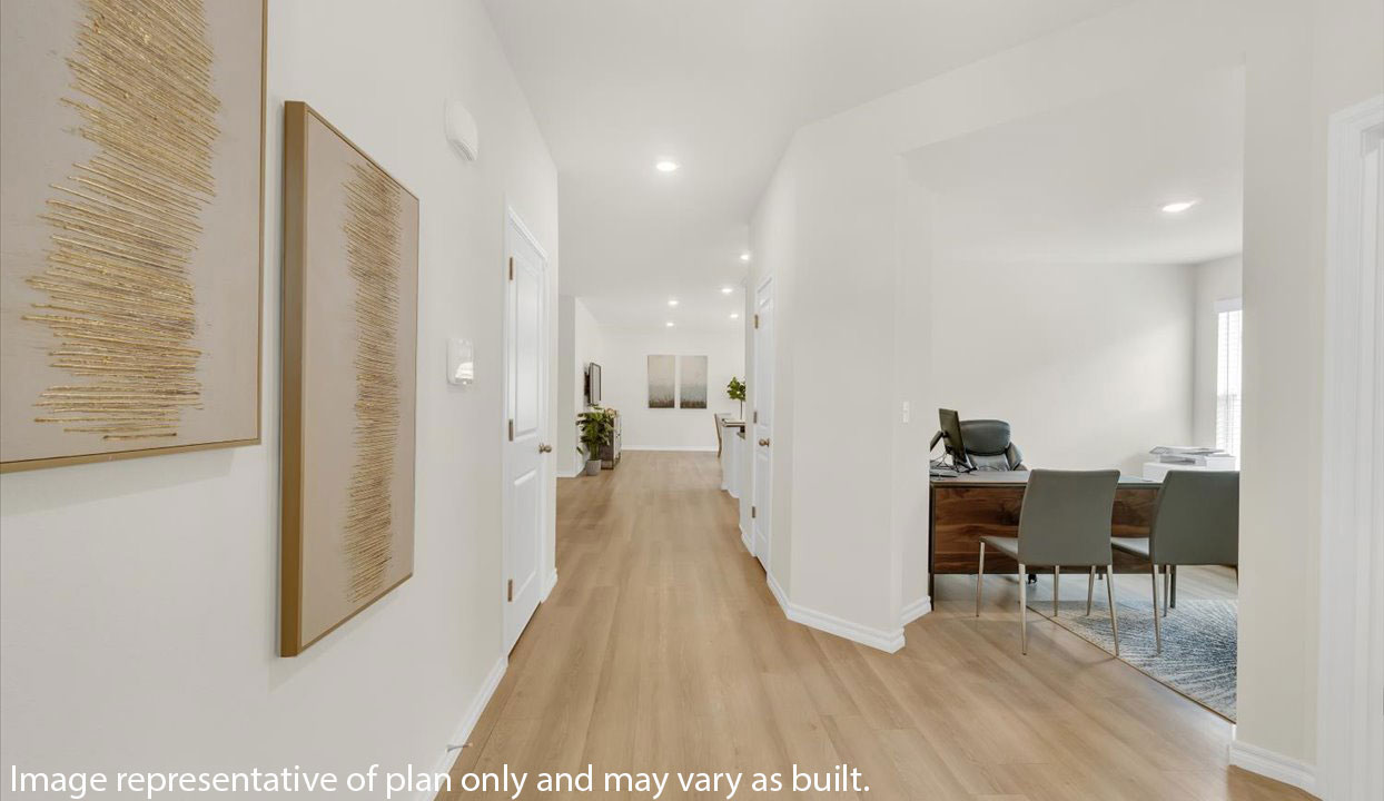 A bright hallway with abstract wall art and light wood flooring leads to a living area, with a home office visible on the right.