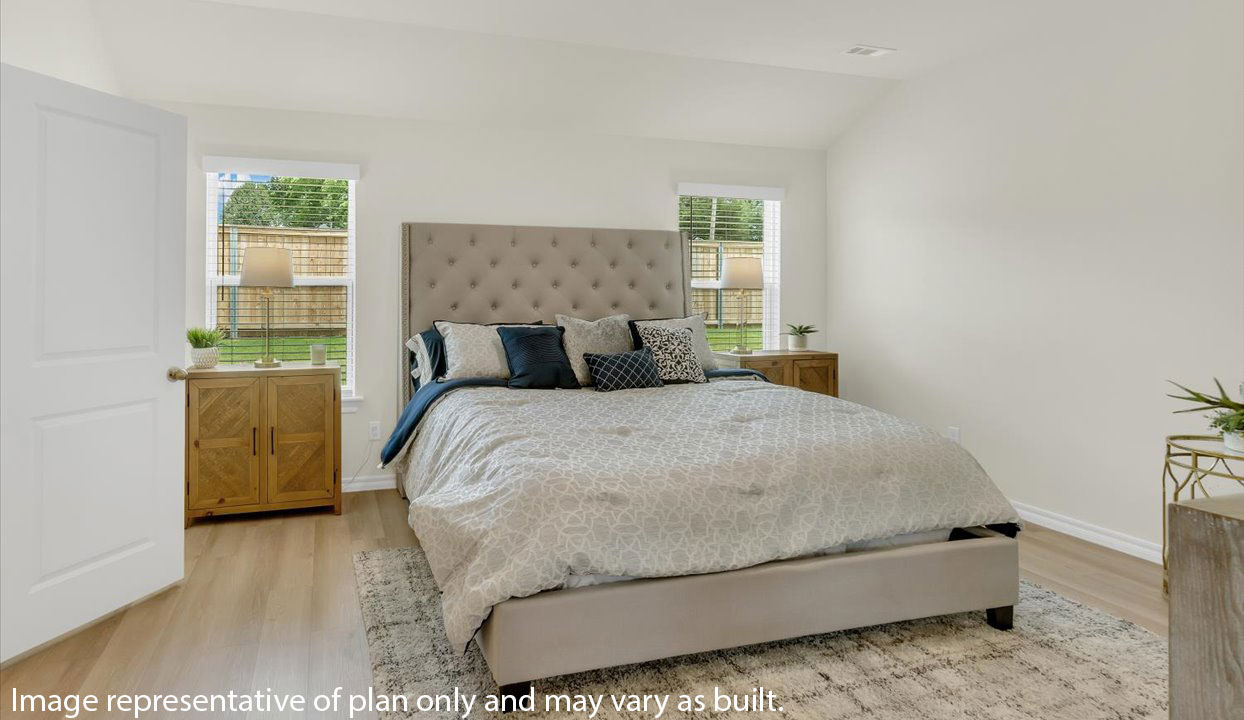 Primary Bedroom with white walls featuring large bed and nightstands. Doorway into the master bathroom.