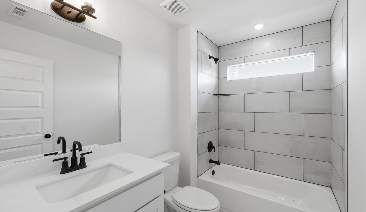 Secondary bathroom with quartz countertop vanity