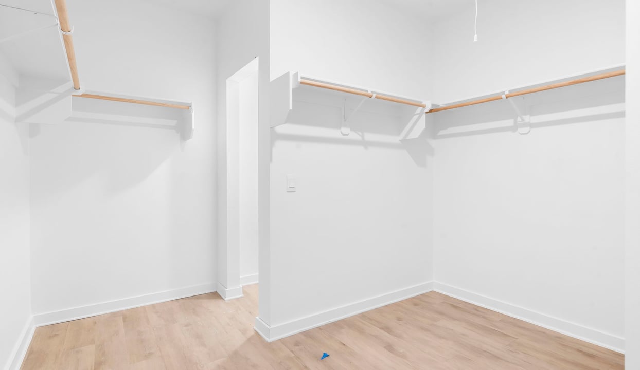 Primary closet with an abundance of hanging space