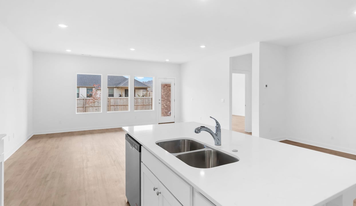 Kitchen and living room with windows looking into the backyard