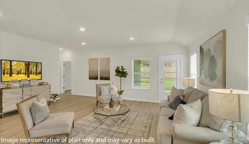 Open concept living space featuring a spacious living room area. Door leading to back patio area.
