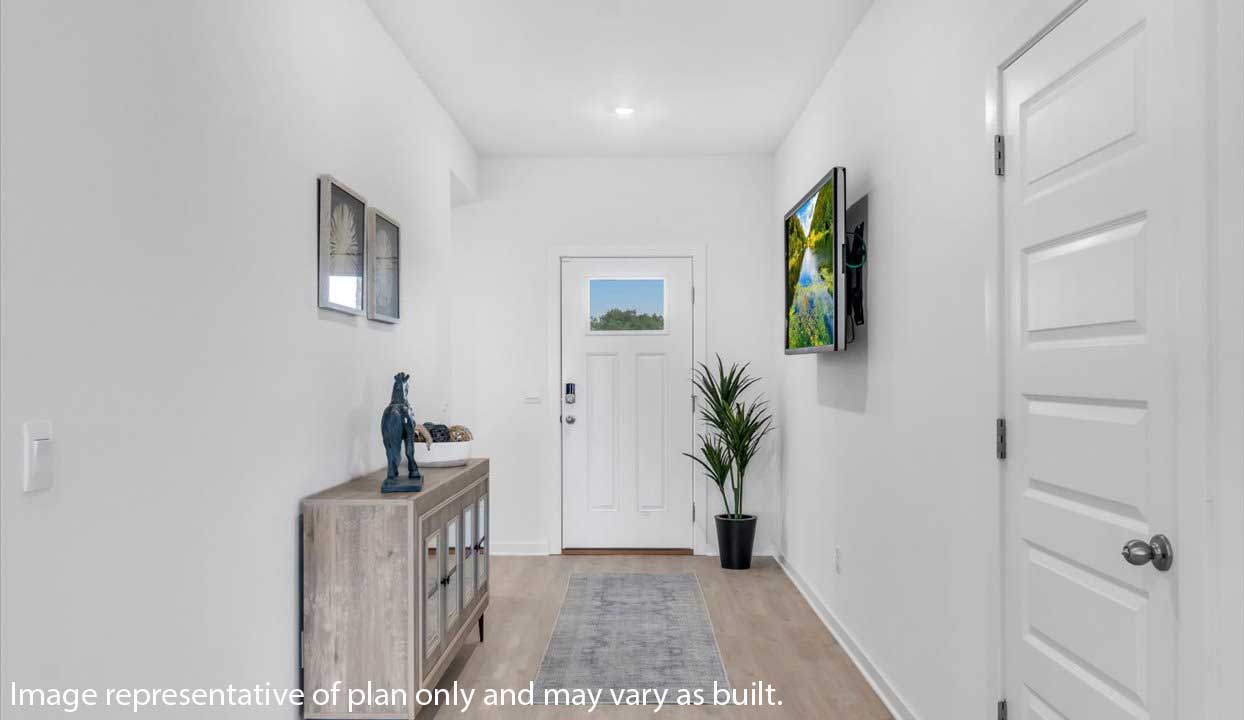 Bright bedroom with floral bedding, butterfly artwork, and large window for natural light.