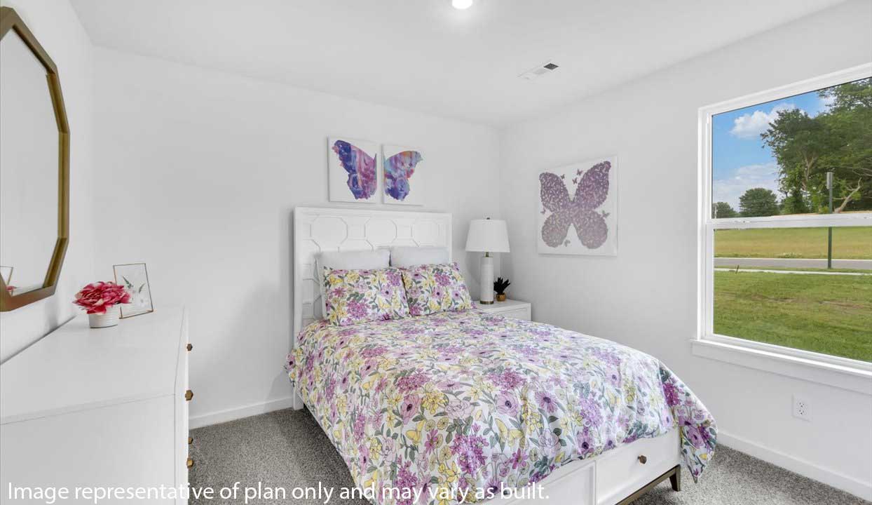 Bright bedroom with floral bedding, butterfly artwork, and large window for natural light.