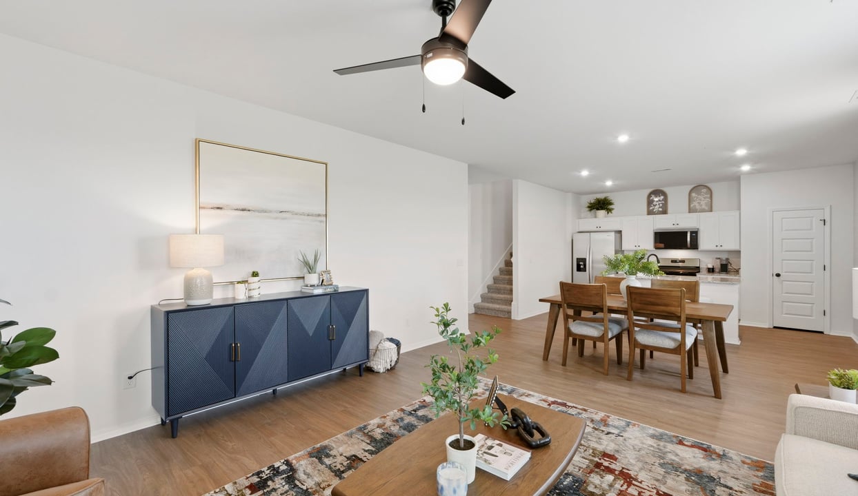 A well-organized living room that includes a kitchen and dining area, creating a warm and welcoming environment for gatherings.