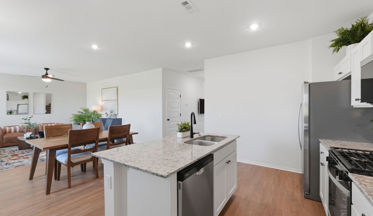 Spacious dining area with vinyl wood flooring, large window and tall ceiling.