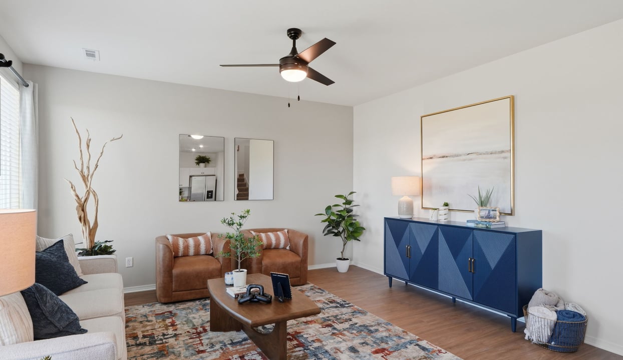 A cozy living room featuring a comfortable couch, a stylish coffee table, and an elegant painting on the wall.