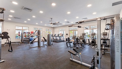 Fitness center with strength machines and weights.
