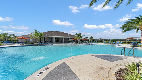 Sunny day at the community swimming pool with lounge seating.