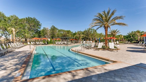 Sunny day at the community swimming pool with lounge seating.