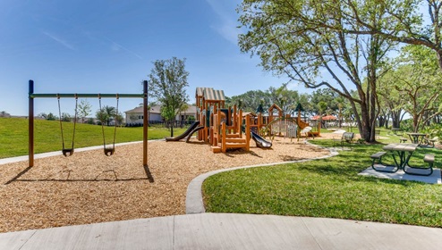 Kids outdoor playground with slide and swings.