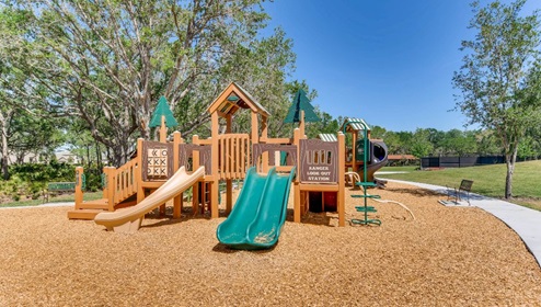 Kids outdoor playground with slide and swings.